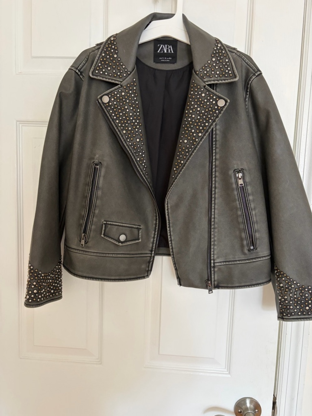 Zara black Studded Faux Leather Moto Jacket can fit women size. Xs.